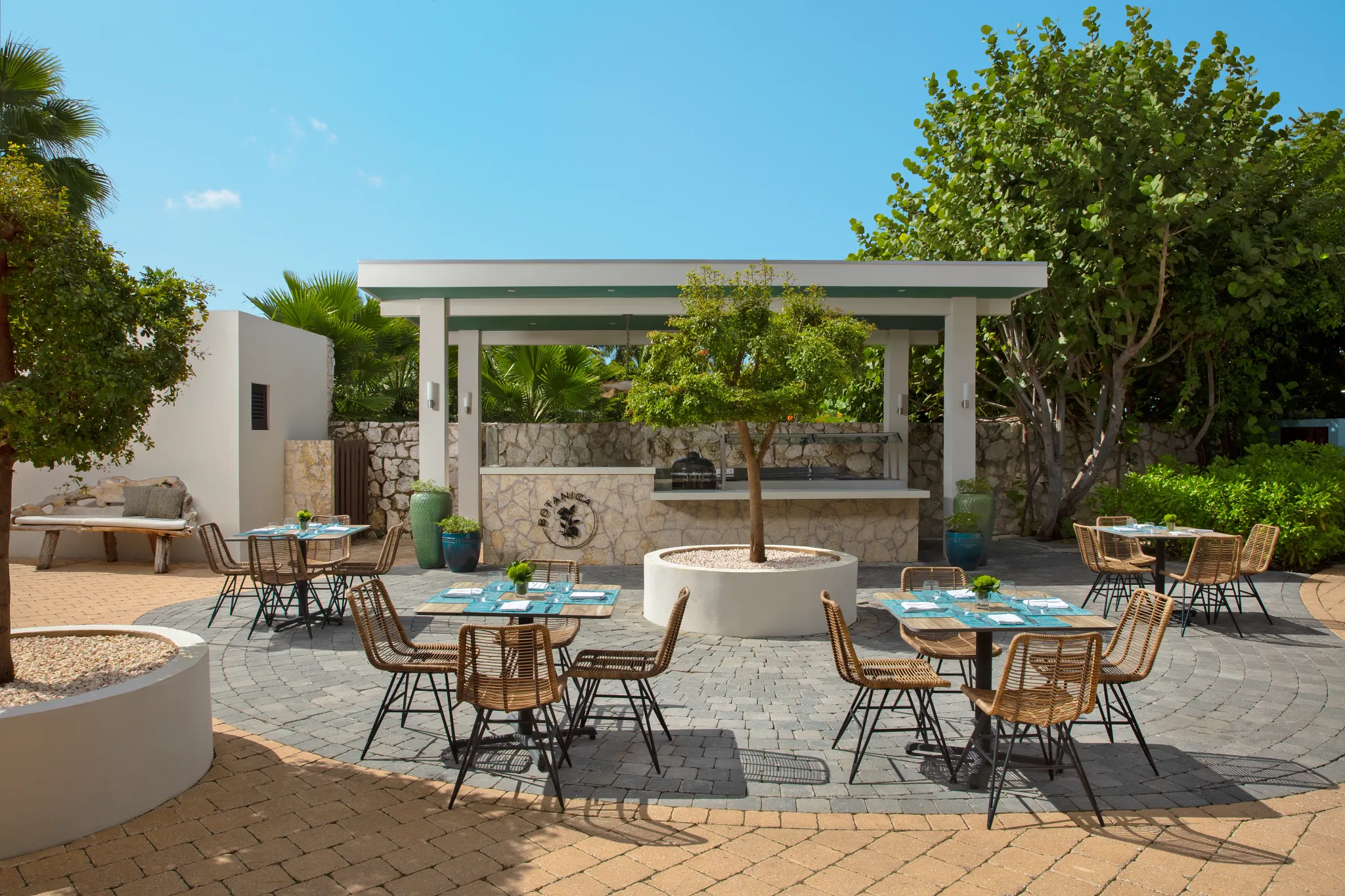 Botanica poolside restaurant at Zoëtry Curaçao Resort & Spa featuring open-air dining, tropical garden surroundings, and casual elegant ambiance.