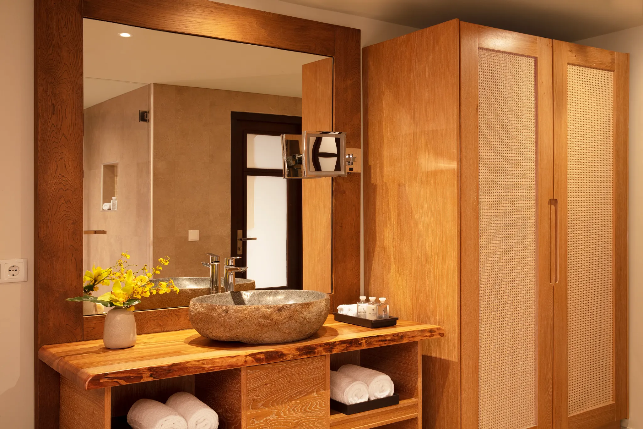 Junior Suite Tropical View bathroom with stone vanity and walk-in shower at Zoëtry Curaçao Resort & Spa.