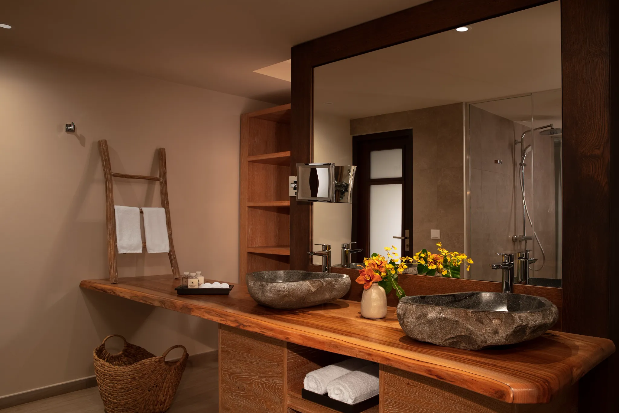 Master Suite Tropical Garden View bathroom with double stone vanities at Zoëtry Curaçao Resort & Spa.