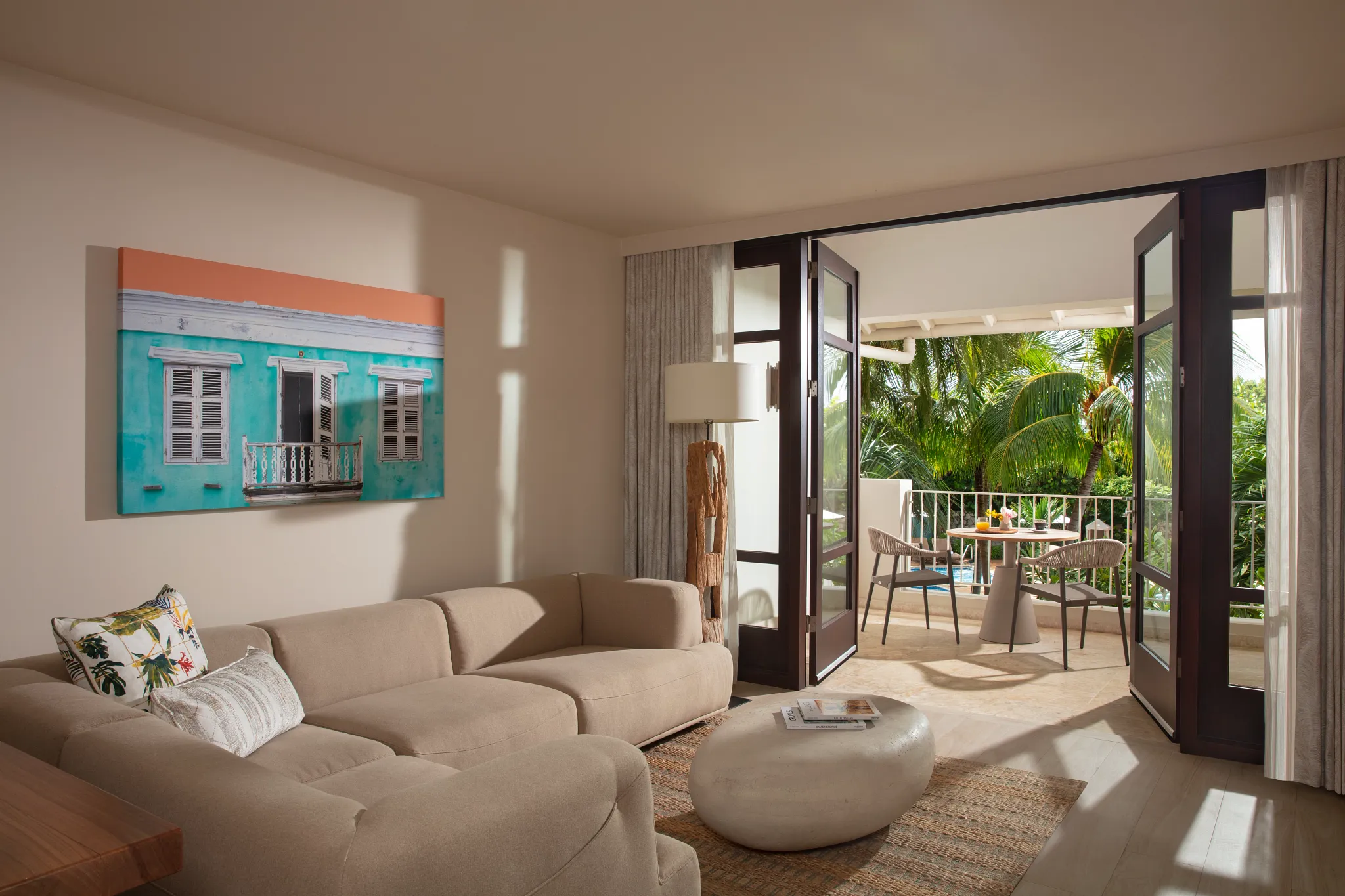 Master Suite Tropical Garden View living area with sofa and terrace access at Zoëtry Curaçao Resort & Spa.