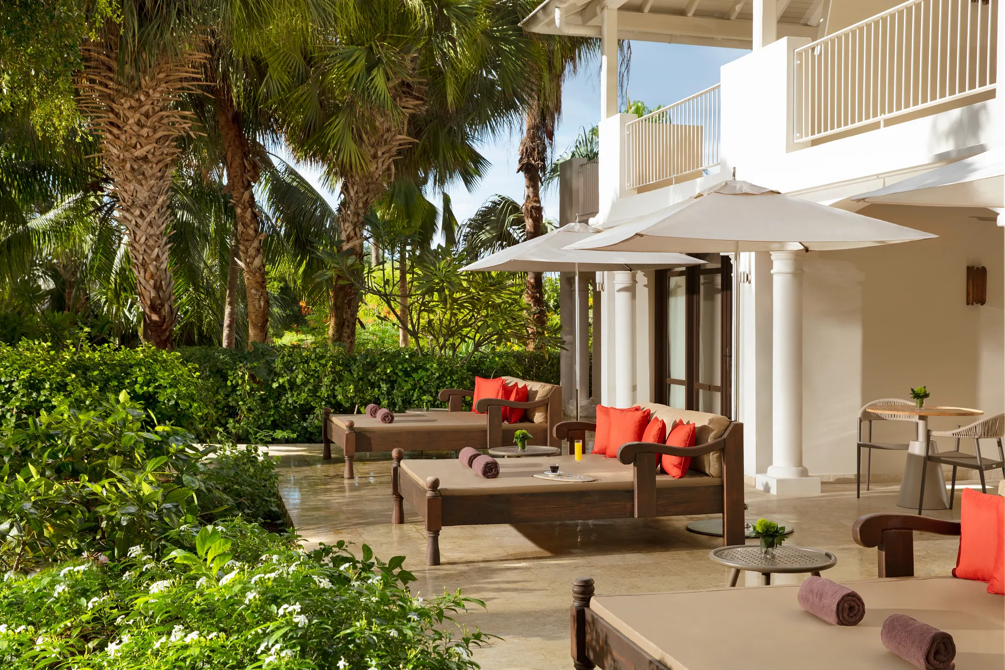 Private terrace with lounge beds and garden views from the Master Suite at Zoëtry Curaçao Resort & Spa.