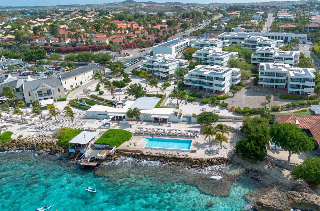Papagayo Beach Hotel Curaçao beachfront property with beach club atmosphere, pools, and vibrant social scene in Jan Thiel.