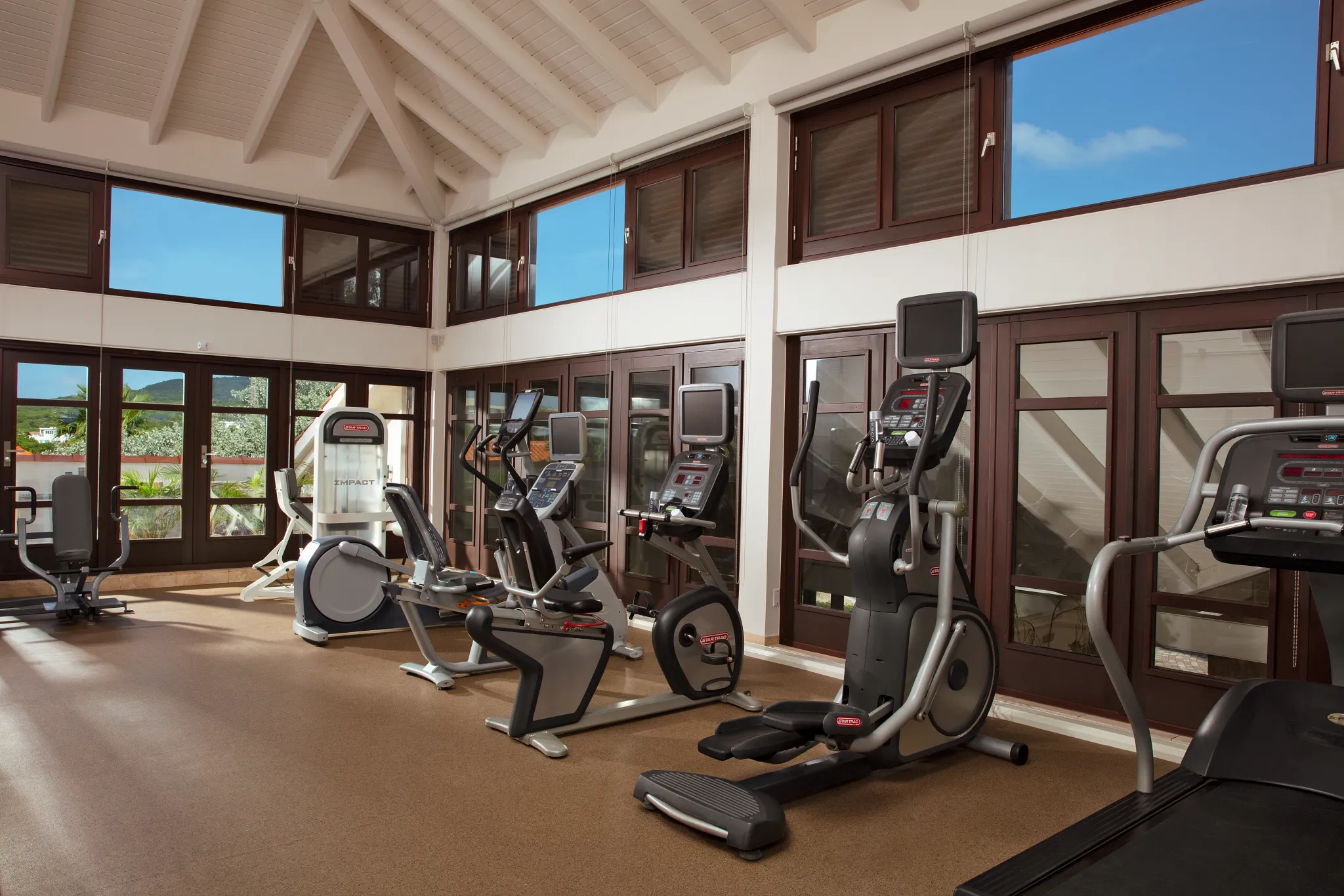 Modern fitness center with cardio equipment at Zoëtry Curaçao Resort & Spa, supporting wellness-focused travel.