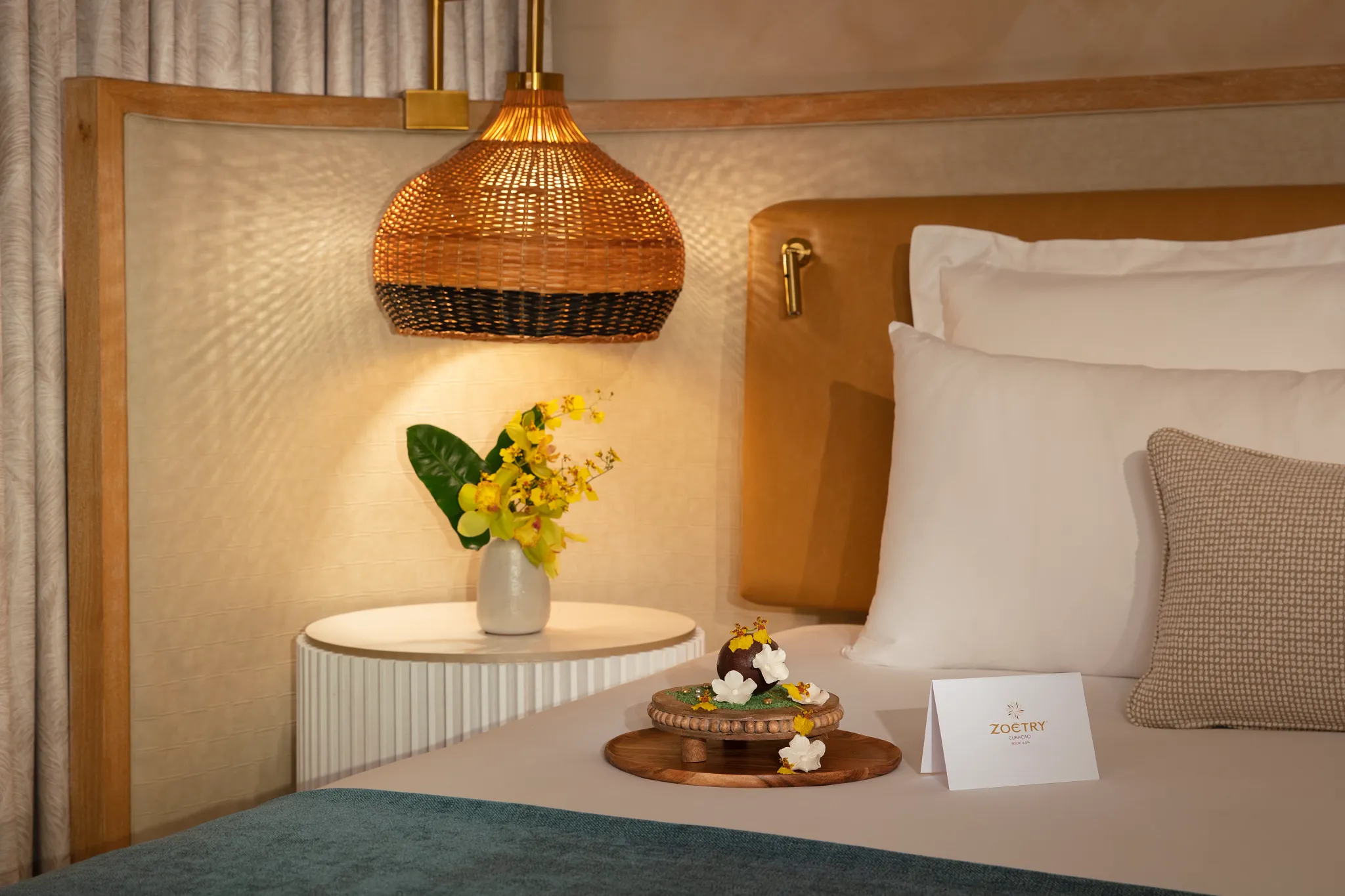Elegant in-room welcome amenity displayed on a luxury bed at Zoëtry Curaçao Resort & Spa, enhancing the resort’s refined hospitality.